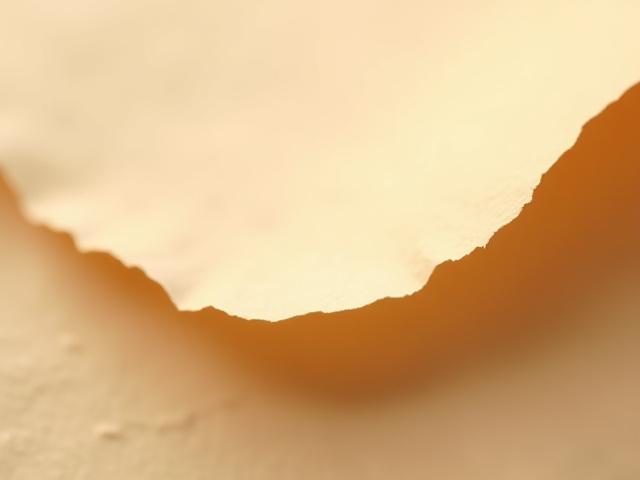 Macro shot of handmade paper with a unique, raw, deckled edge